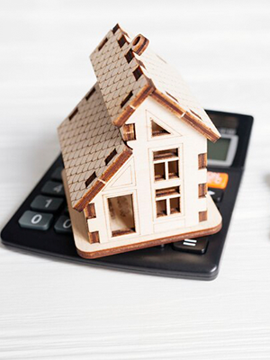 white and red wooden house miniature on brown table